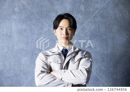 Men in work clothes with arms folded Men in work clothes with arms folded 126744956