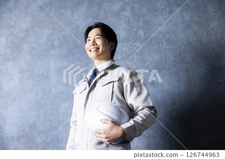Men in work clothes with arms folded 126744963