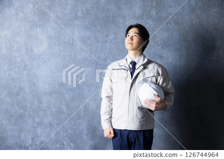 Men in work clothes with arms folded Men in work clothes with arms folded 126744964