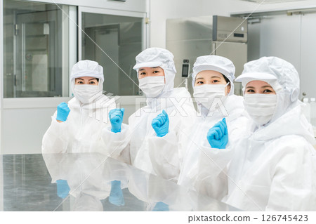 Male and female staff working in a manufacturing plant wearing protective clothing and clean wear Male and female staff working in a manufacturing plant wearing protective clothing and clean wear 126745423