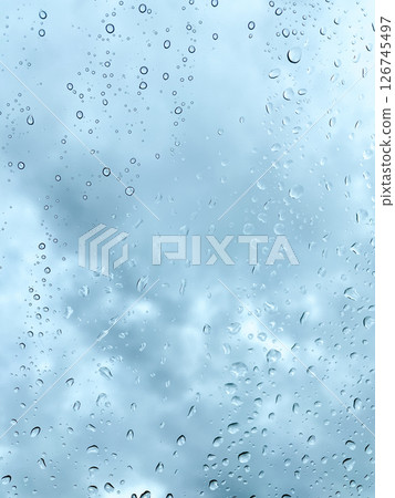 Raindrops on Window with Moody Cloudy Sky 126745497