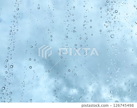 Raindrops on Window with Moody Cloudy Sky 126745498