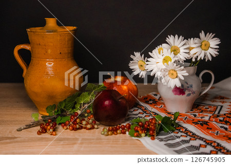 a pitcher of chamomile and an apple a pitcher of chamomile and an apple 126745905