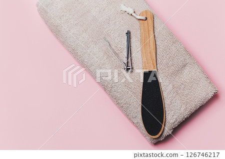 Wooden Heel Scrubber for Foot Peeling and Steel Nail Cut on Towel on Pink Wooden Heel Scrubber for Foot Peeling and Steel Nail Cut on Towel on Pink 126746217