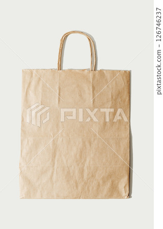 Paper bag. Kraft folded paper shopping bag on white Paper bag. Kraft folded paper shopping bag on white 126746237