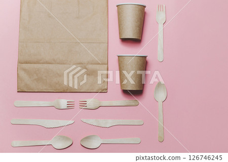 Flat lay composition with eco friendly paper disposable tableware on pink background. Flat lay composition with eco friendly paper disposable tableware on pink background. 126746245