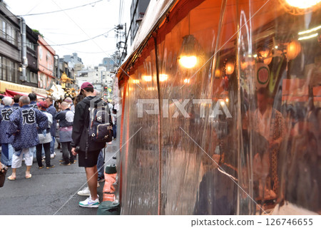 Hoppy Street is lined with drinking establishments covered in plastic sheets to protect from the rain. Hoppy Street is lined with drinking establishments covered in plastic sheets to protect from the rain. 126746655