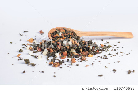Dry green tea with fruit pieces on wooden spoon on white background. Drinks, organic product and health. 126746685