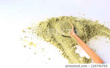 Japanese powdered matcha green tea on wooden spoon. Antioxidant, healthy, organic product. Beverages and nutrition. Isolated image on white background. 126746769