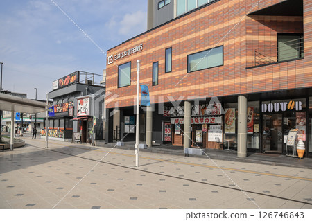 March 28 2025 Urban Streetscape Featuring Shops, Sidewalks, Landscaping 126746843