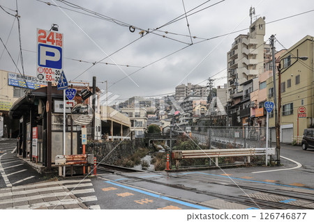 March 28 2025 Tram Crossing Scenic Urban Street, Hillside Neighborhood, Japan 126746877
