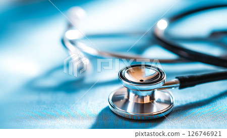 A shiny stainless steel stethoscope on a blue background, a symbol of health 126746921