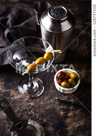 Traditional martini cocktail with olives and Traditional martini cocktail with olives and 126747208
