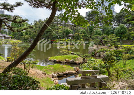 Traditional Shukkei-en Japanese garden with pond in Hiroshima, Japan Traditional Shukkei-en Japanese garden with pond in Hiroshima, Japan 126748730