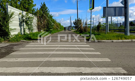 Pedestrian crossing on asphalt road, urban journey. Safe crossing point provides peaceful urban Pedestrian crossing on asphalt road, urban journey. Safe crossing point provides peaceful urban 126749057