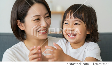 Mother and child playing together in the living room 126749652
