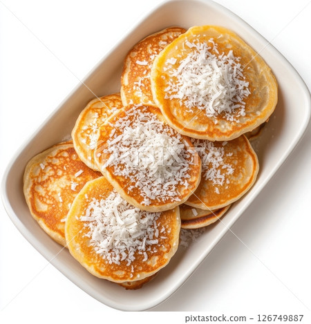 Warm Thai Coconut Pancakes Topped with Shredded Coconut in Dish Warm Thai Coconut Pancakes Topped with Shredded Coconut in Dish 126749887