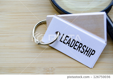 Leadership text on notepad highlighting the core of organizational direction and influence 126750036
