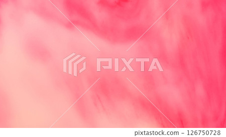 Dreamy red-pink abstract wash. The image fades gently from coral to rose hues with soft, cloudy textures. ideal as a romantic, calming background. 126750728