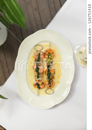 Portion of grilled shrimp skewers with sauce Portion of grilled shrimp skewers with sauce 126751419