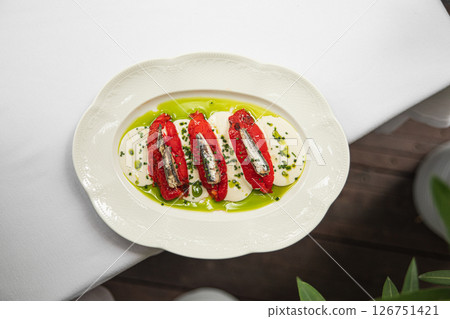 Portion of baked pepper appetizer with small fish Portion of baked pepper appetizer with small fish 126751421
