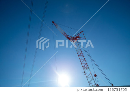 A crane extending into the blue sky A crane extending into the blue sky 126751705