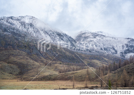 Mountain landscape of Chuysky Trakt Altai Russia. Expansive natural scenery featuring rugged peaks and valleys. Mountain landscape of Chuysky Trakt Altai Russia. Expansive natural scenery featuring rugged peaks and valleys. 126751852