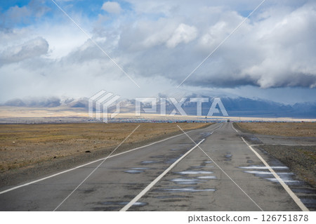 Road from the Mongolian border to Kosh-Agach Altai Russia in a remote mountain landscape. Scenic route through steppe and rugged terrain connecting two regions. Road from the Mongolian border to Kosh-Agach Altai Russia in a remote mountain landscape. Scenic route through steppe and rugged terrain connecting two regions. 126751878