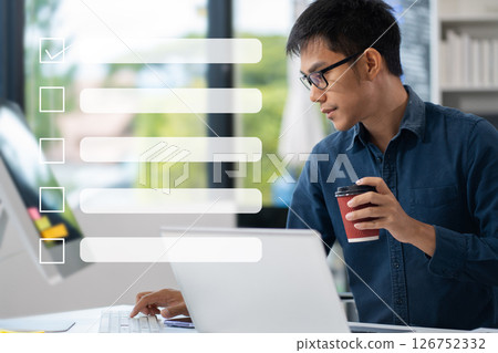 Business performance checklist concept, businessman using tablet and laptop doing online checklist survey, filling out digital form checklist. 126752332