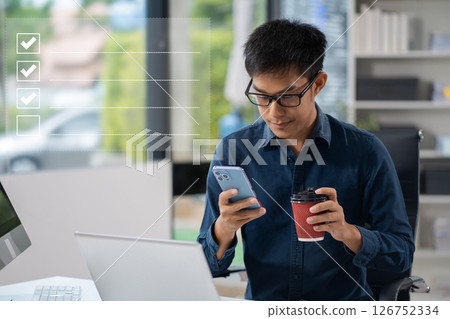 Businessman using tablet to do online checklist survey, doing assessment online survey answer test questions Digital form. 126752334