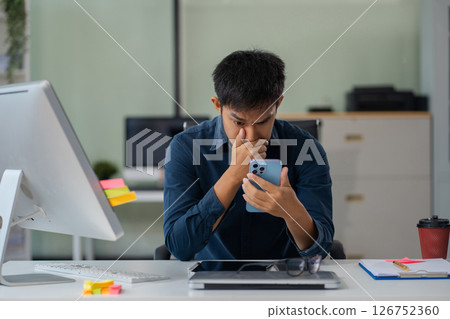 stressed asian businessman working in the office. Businessman thinking too much work concept in the office. stressed asian businessman working in the office. Businessman thinking too much work concept in the office. 126752360