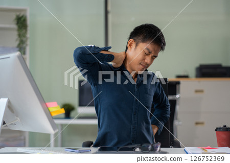 Male businessman is doing a stretchy posture due to sitting in the office for too long, office syndrome concept. 126752369