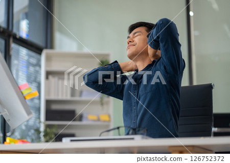Male businessman is doing a stretchy posture due to sitting in the office for too long, office syndrome concept. 126752372