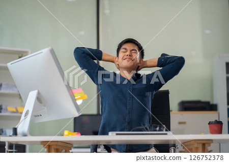 Male businessman is doing a stretchy posture due to sitting in the office for too long, office syndrome concept. 126752378