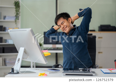 Male businessman is doing a stretchy posture due to sitting in the office for too long, office syndrome concept. 126752379