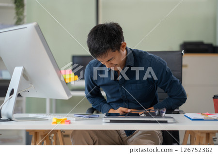 Diarrhea or constipation, problems with health concept. Closeup man sitting at table in office feeling pain in stomach touching it with hands having Abdomen disease and illness. Diarrhea or constipation, problems with health concept. Closeup man sitting at table in office feeling pain in stomach touching it with hands having Abdomen disease and illness. 126752382