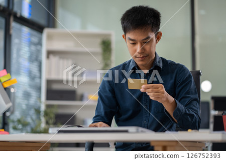 Businessman calculating monthly office expenses, taxes, bank account balance and credit card bills payment. 126752393