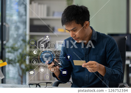 Asian man stressed over credit card debt, holding bills in frustration. Financial anxiety and economic burden concept in a realistic lifestyle setting. Asian man stressed over credit card debt, holding bills in frustration. Financial anxiety and economic burden concept in a realistic lifestyle setting. 126752394