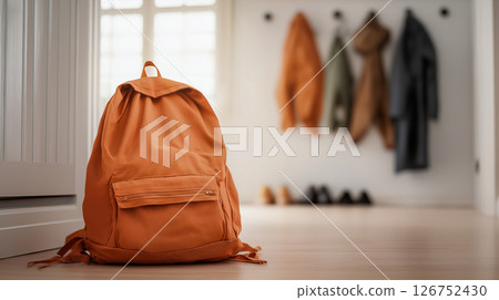 Stylish school backpack placed in a cozy hallway 126752430