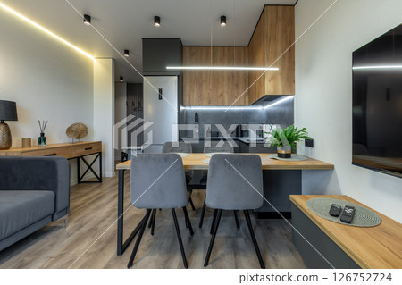 Cozy Open Kitchen and Living Room with Wooden Elements 126752724