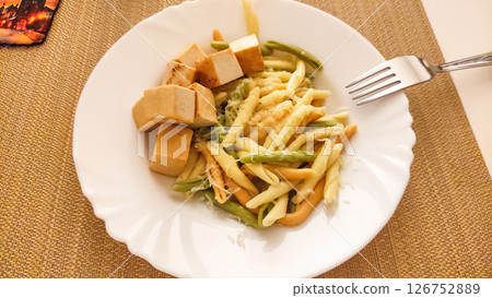 Strozzapreti pasta with tofu and green beans on white plate Strozzapreti pasta with tofu and green beans on white plate 126752889