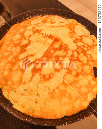 Cooking delicious french crepe on frying pan for breakfast Cooking delicious french crepe on frying pan for breakfast 126752912
