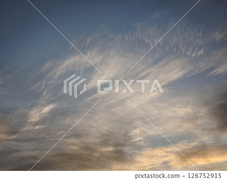 Wispy clouds drifting across tranquil november sky, illuminating mountainous landscapes of chamonix and aosta valley with soft sunset glow 126752915