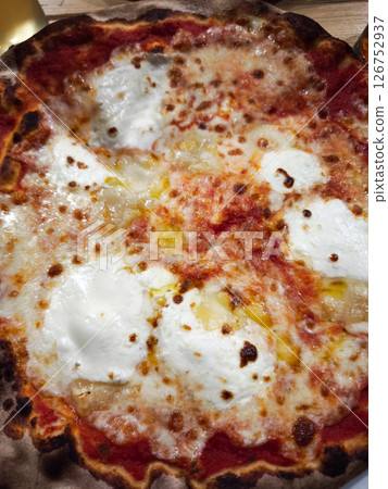 Freshly baked cheese pizza with golden crispy crust, vibrant tomato sauce, and gooey melted mozzarella representing classic italian flavors 126752937