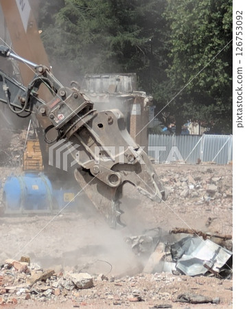 Demolition of Shopping centre Offices by an Industrial Grab Crusher Hydraulic Excavator Demolition of Shopping centre Offices by an Industrial Grab Crusher Hydraulic Excavator 126753092