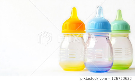 Three baby bottles with different colored lids Three baby bottles with different colored lids 126753623