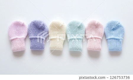 A row of baby mittens in various colors 126753736