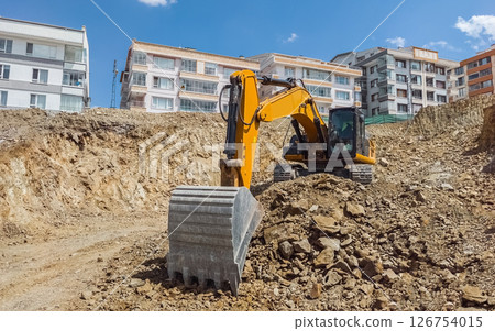 Excavator at urban construction site 126754015