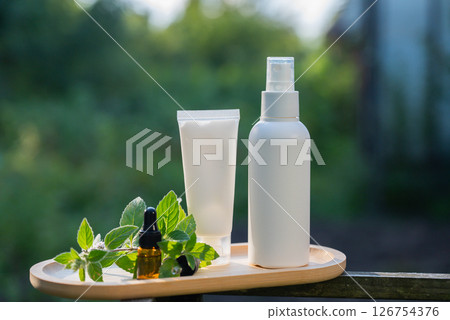 White handmade cosmetic bottles template mockup skin care herbal alternative Insect repellent outdoors during summer. Trying to kill mosquitoes and flies with organic ingredients mint extract oil 126754376