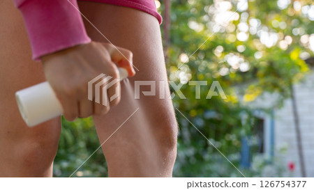 Hand applying insect repellent mosquito insecticide spray to kill flies bugs and mosquitoes on skin outside. Malaria zika virus and dengue fever prevention 126754377